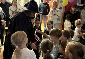 Dzieci losują z andrzejkowego worka przedmiot - atrybut przyszłego zawodu