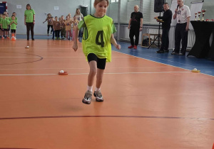 Dziewczynka - kapitan drużyny rozpoczyna pierwszą konkurencję sportową