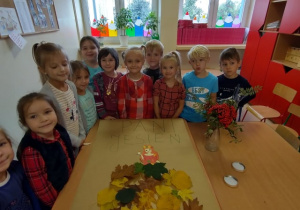 Dzieci pozują do zdjęcia z "Panią Jesienią"