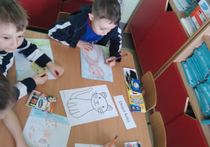 Dzieci kolorują narysowany przez siebie rysunek kota