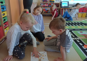 Dzieci układają puzzle - pocięte w linii prostej ilustracje wiosennych kwiatów