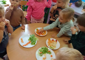 Dzieci jedzą owoce wykorzystane do kreatywnych zabaw ze sztuką
