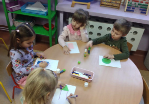 Dzieci rozwijają swoją kreatywność i pomysłowość dorysowując do przyklejonej figury charakterystyczne elementy tworząc spójną pracę
