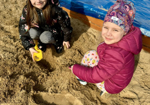Dziewczynki bawią się na piasku