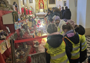 Dzieci z zachwytem oglądają Szopki Bożonarodzeniowe i ozdoby świąteczne